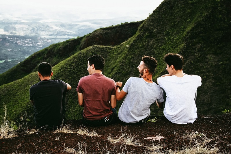 Men sitting on the grounds laughing