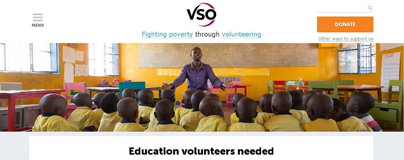 A man teacher in a classroom with children